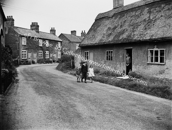 VILLAGE STREET WITH THATCHED COTTAGE